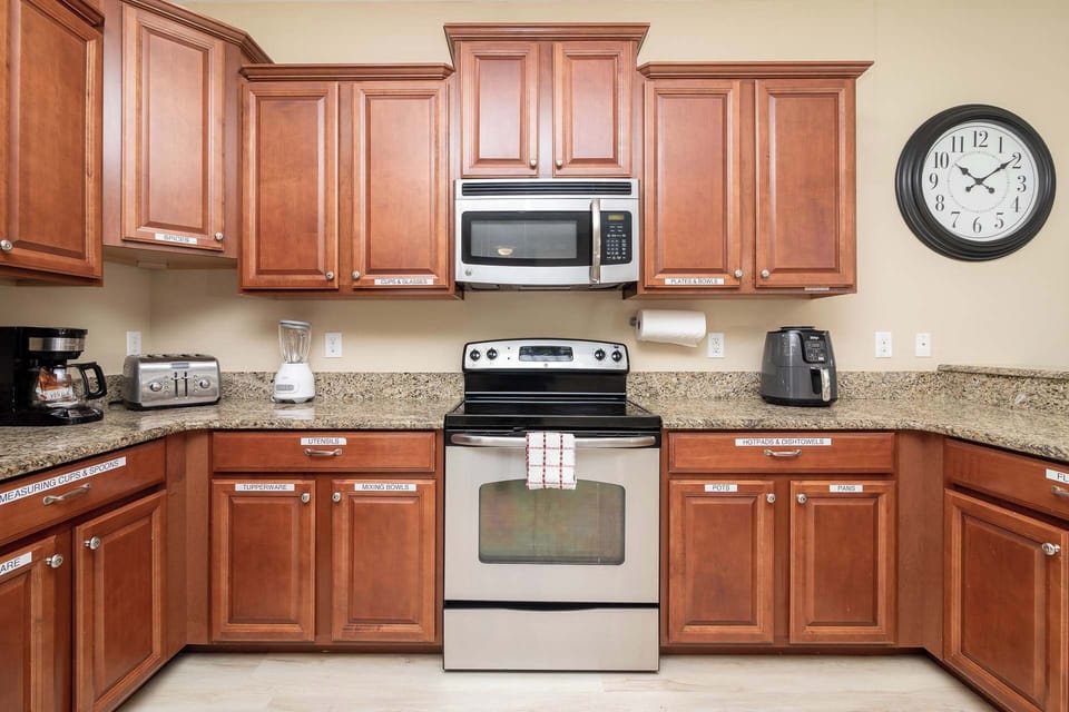 The chic, open kitchen offers ample space & all the comforts of home