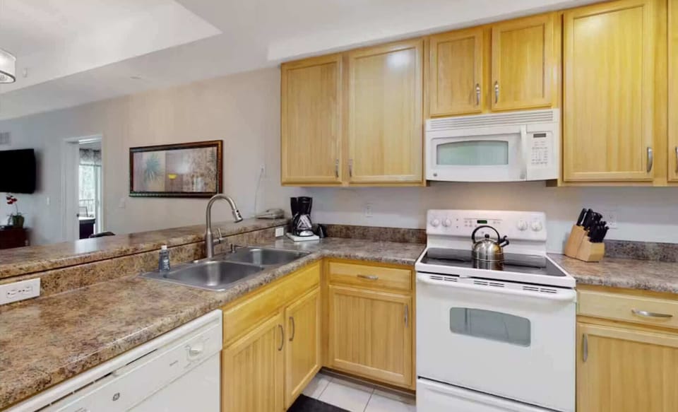 The cozy kitchen offers ample space & all the comforts of home