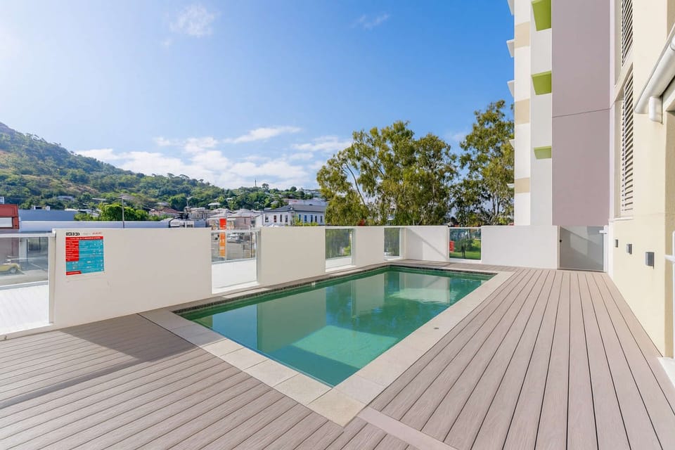 Outdoor swimming pool and sun deck at Kensington Apartments