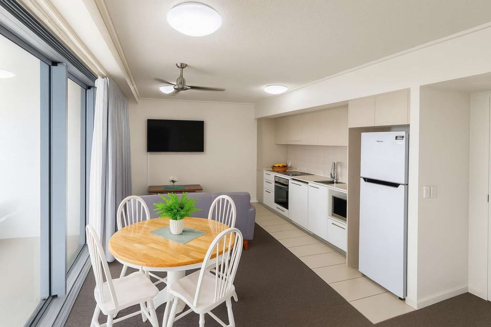 Dining area and fully equipped kitchen in apartment