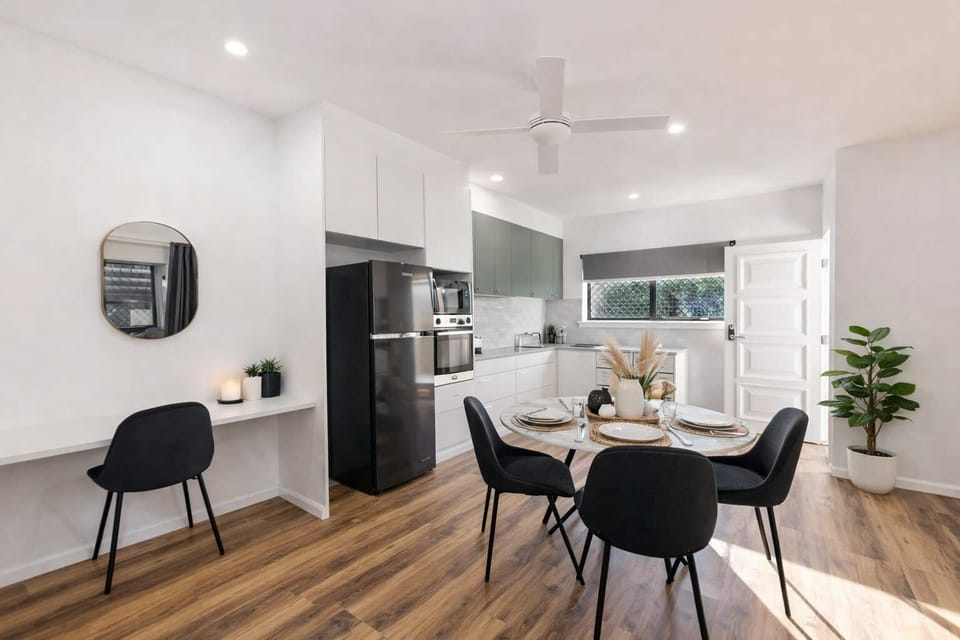 Stylish open-plan kitchen and dining area with modern décor and natural light
