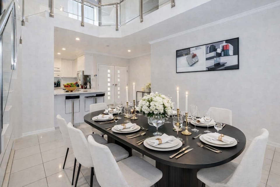 Open-plan staircase and dining area in contemporary coastal-style home