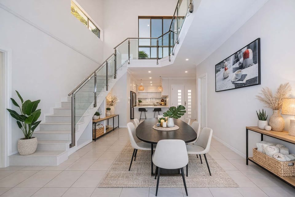 Contemporary open-plan design with staircase and dining area in modern Townsville accommodation