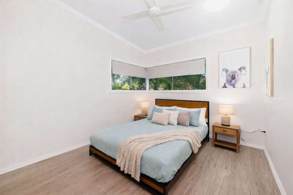 Comfortable queen bedroom with ceiling fan and built-in storage – ideal for couples or extended stays in Townsville