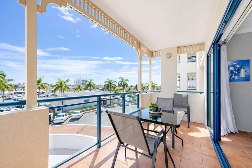 Balcony Seating Area Overlooking Palm Trees and Marina