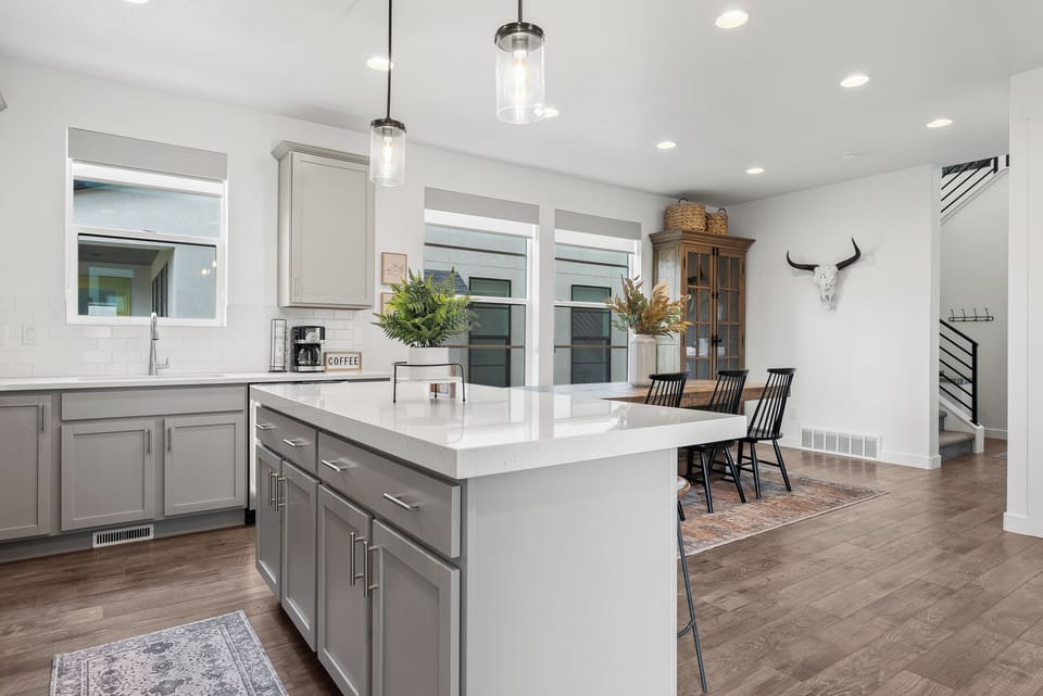 A well appointed chefs kitchen with upgraded stainless steel appliances and fully stocked