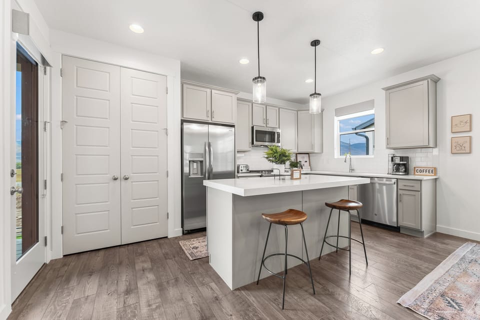 A well appointed chefs kitchen with upgraded stainless steel appliances and fully stocked