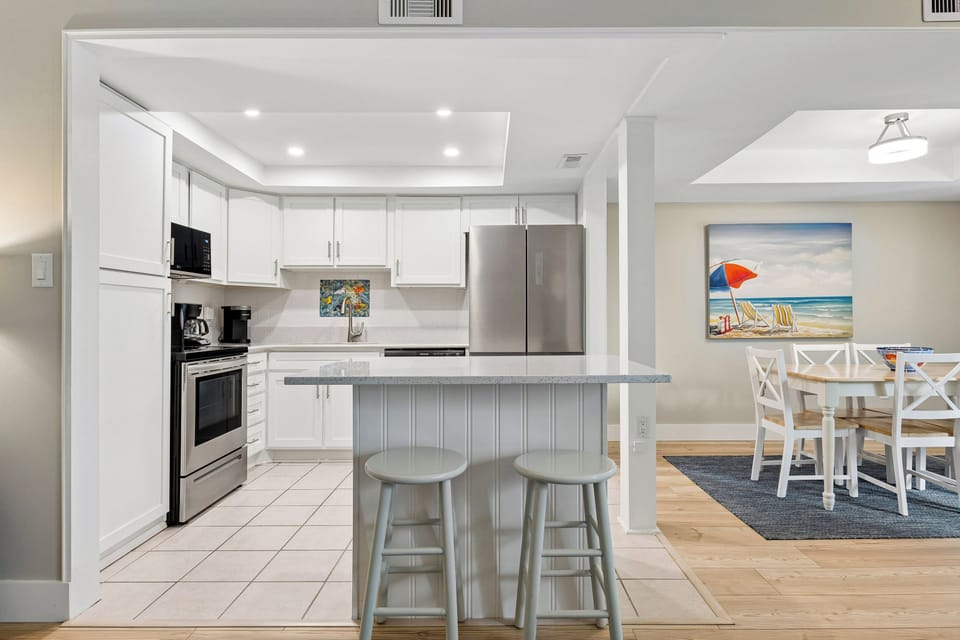 Fully stocked kitchen with all stainless steel appliances.