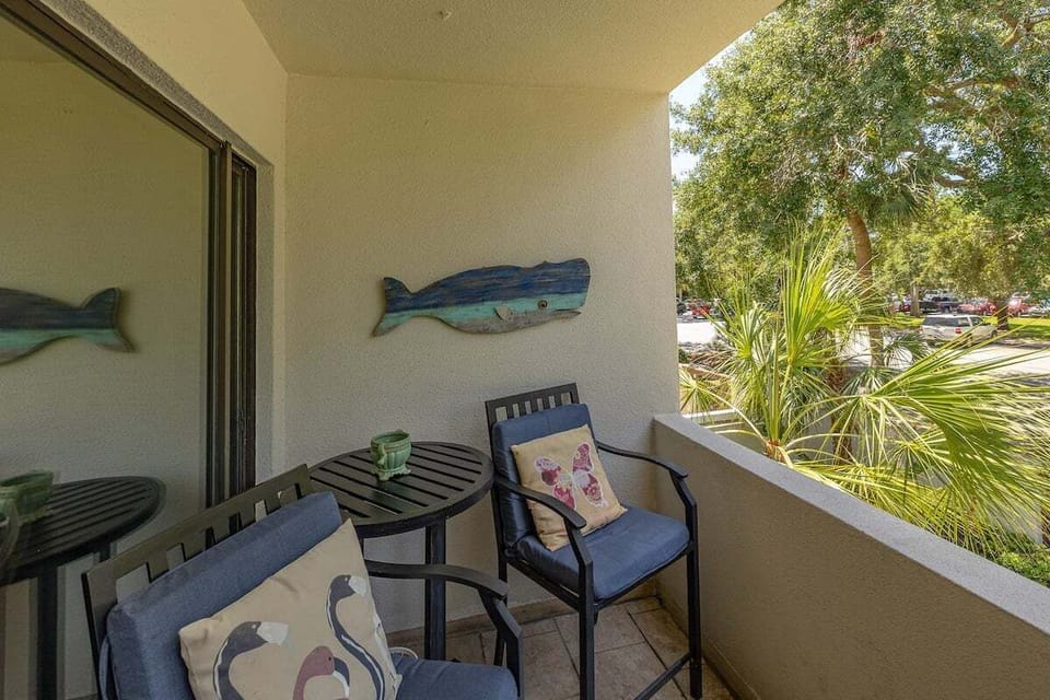 Balcony with decorative fish art and bistro seating