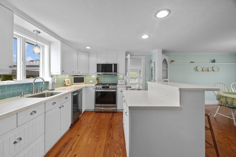 Fully equipped kitchen with stainless steel appliances - dishwasher, convection oven, microwave, toaster, Keurig, and regular coffee maker