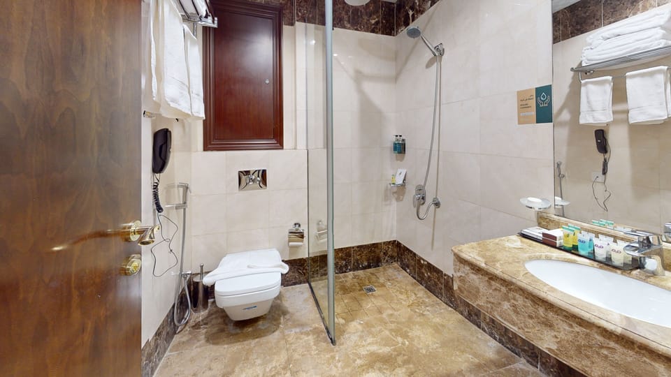 Combined shower/tub, hair dryer, slippers, bidet