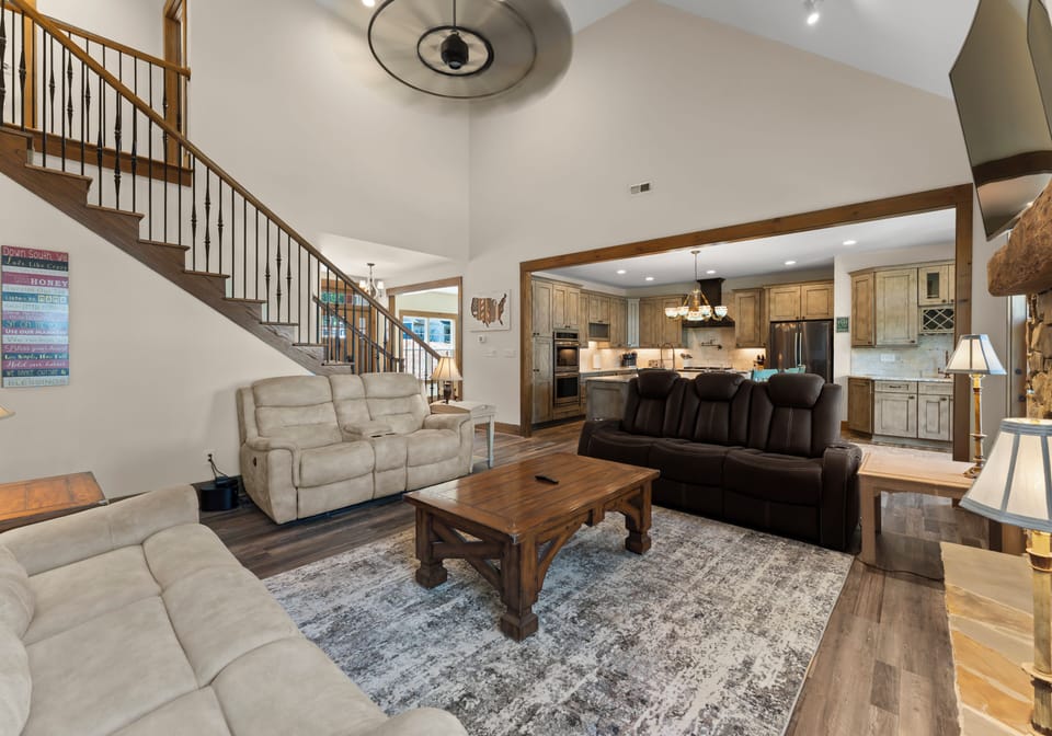 Staircase view from the living room, highlighting open railings and layout.