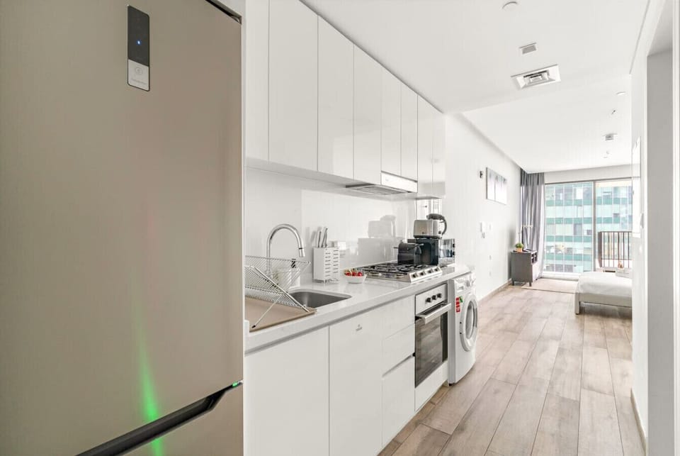 Kitchen: Sleek appliances and natural light make meal prep a delight in this modern space!