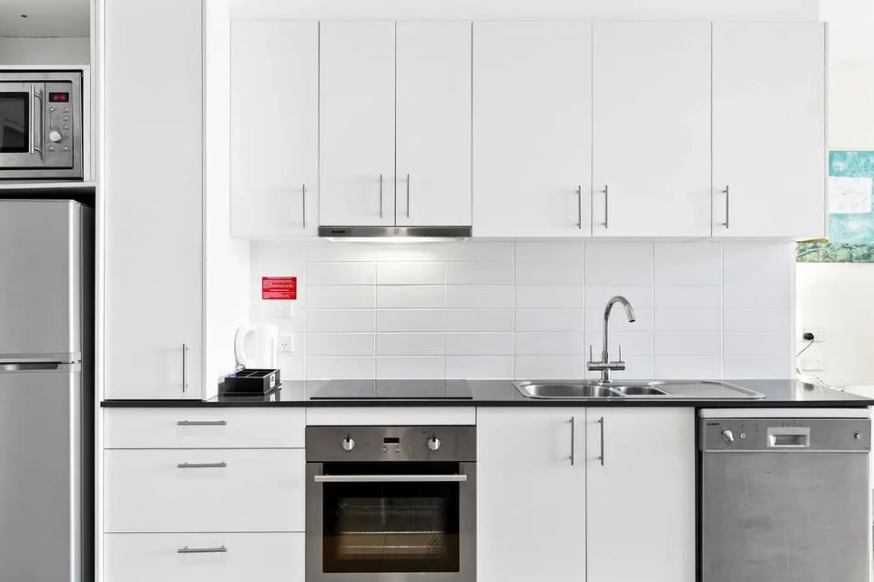Full kitchen with dishwasher, cooktop, oven, full fridge, microwave.