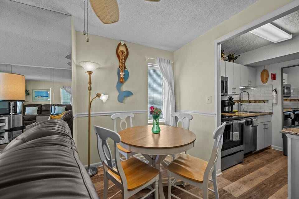 Cozy dining nook perfect for meals and game nights, just steps from the kitchen and oceanfront living room.