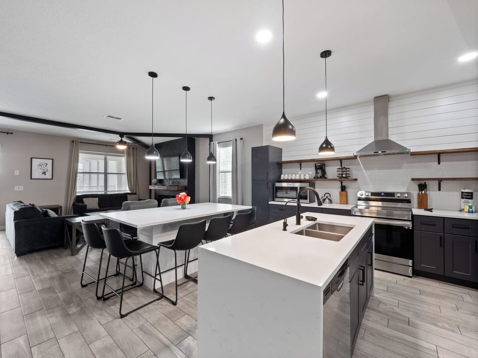 Spacious Downstairs Area with Full Size Kitchen, Dining Table, and Comfortable Lounge
