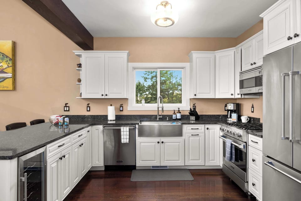 Designed for both function and beauty, this chef’s kitchen includes top-tier appliances, mountain views, and a seamless connection to the main living space.