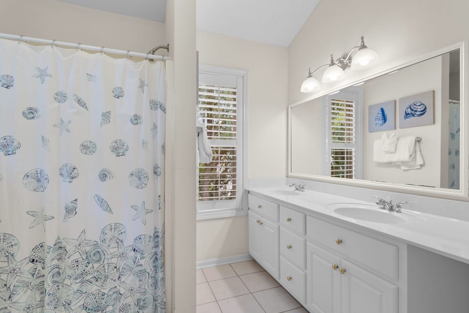 Refresh in your coastal-themed bathroom with dual sinks, ample storage, and charming seashell touches that make morning routines feel like a seaside retreat.