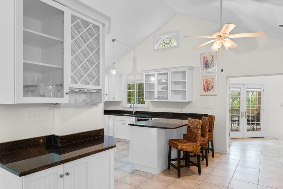 Your spacious gourmet kitchen invites culinary adventures with granite counters, white cabinetry, and charming breakfast bar seating.