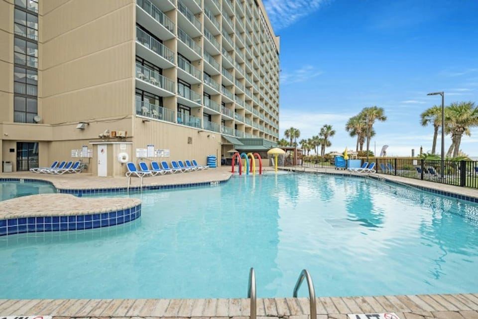 Take a cool dip in the sparkling pool after a fun day at the beach.