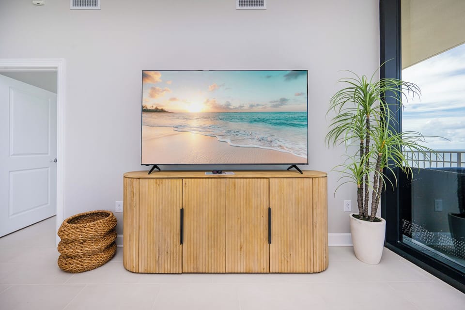 Enjoy your favorite shows on the large TV, complemented by stylish decor and a coastal vibe