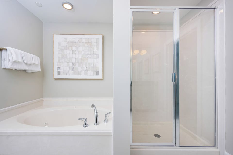 Indulge in relaxation with a soaking jetted tub and separate shower in the master bath, complemented by elegant decor