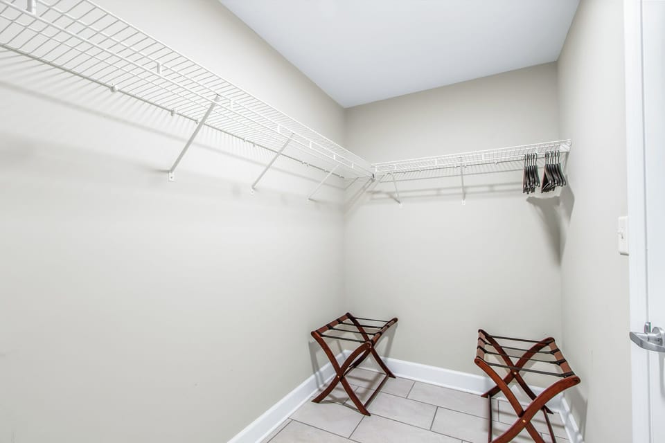 Store your belongings easily in the master closet featuring ample shelving and convenient essentials