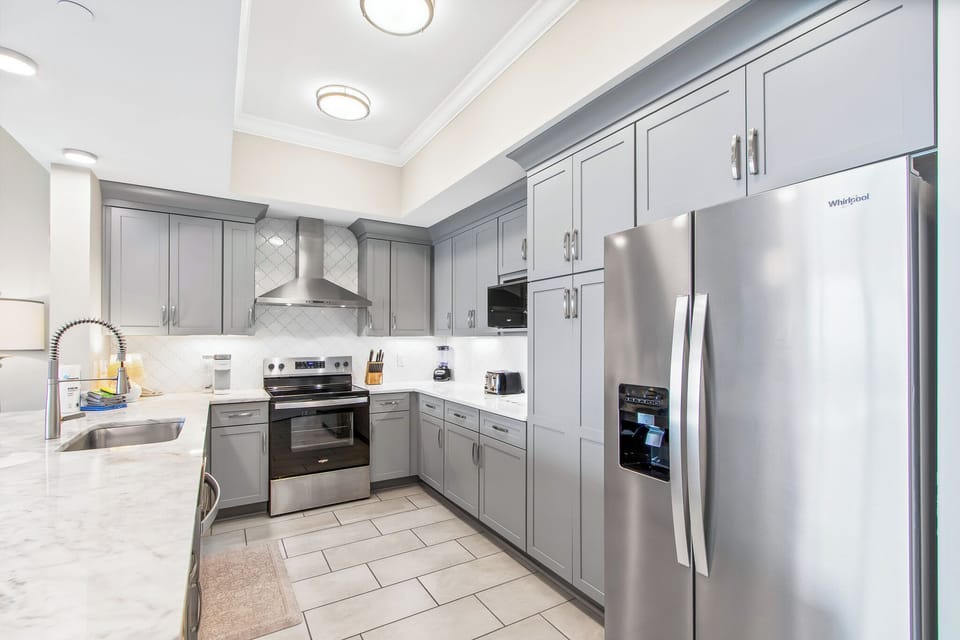 Cook and gather in this stylish kitchen featuring spacious countertops, modern appliances, and sleek cabinetry
