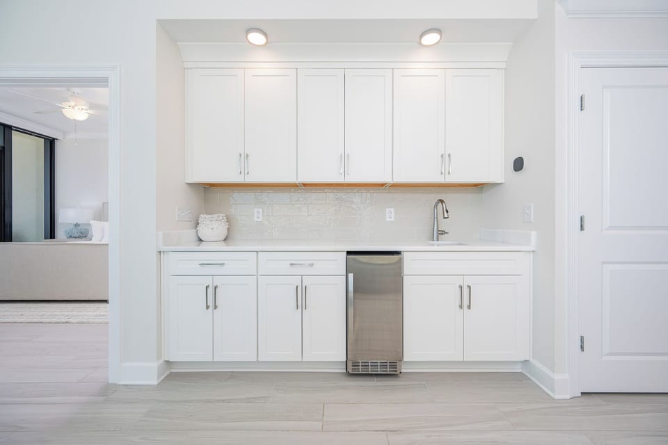 Prepare snacks and drinks at the sleek wet bar, designed for convenience and entertainment