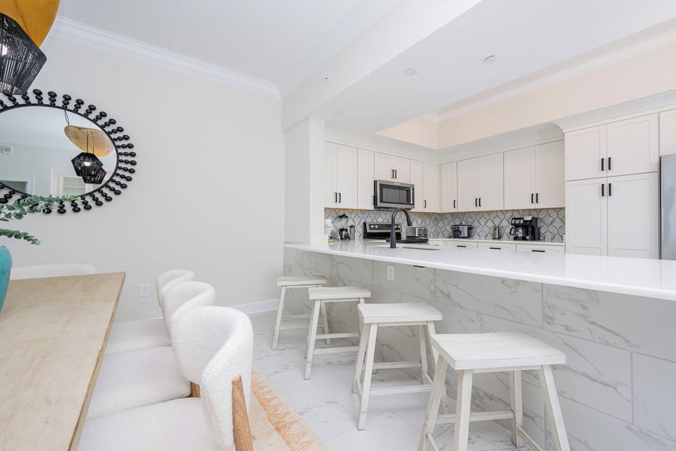Gather around the stylish dining table and enjoy meals while admiring the modern kitchen's sleek design