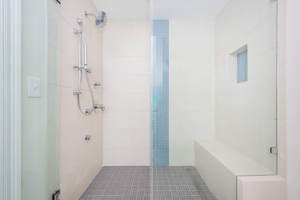 Refreshing shower in the master bathroom featuring sleek fixtures and a spacious modern design