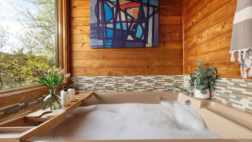 A large window offers breathtaking views of the surrounding mountains in this tranquil retreat lets you unwind in ultimate peace. 