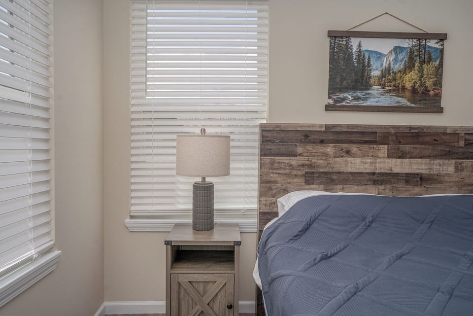 Light-filtering windows and soft linens make this queen room deeply relaxing