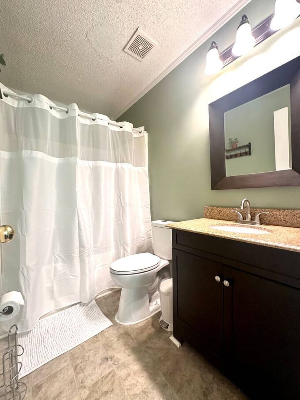 Private full bathroom 1 — freshly stocked with towels, shampoo, conditioner, and body wash