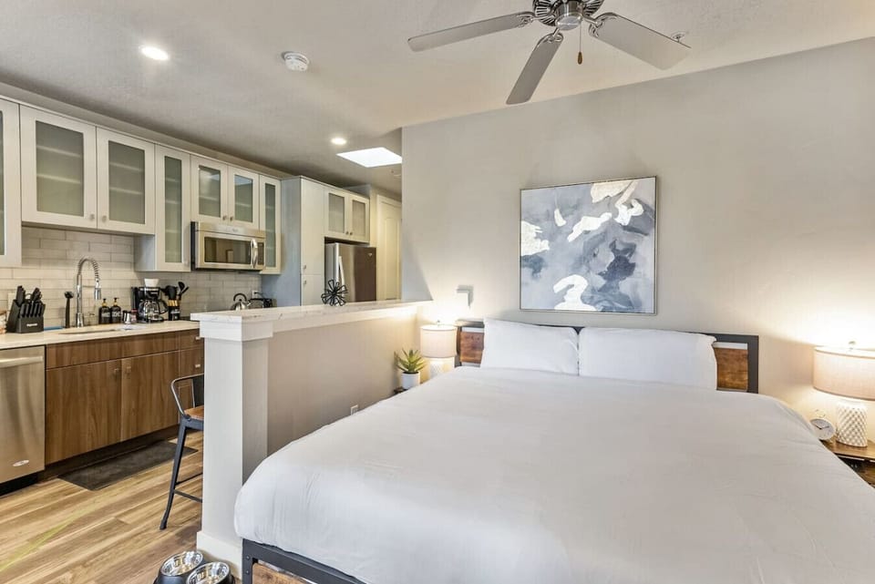 Open bedroom layout w/ bed flowing into kitchen space for a modern studio feelOpen bedroom layout w/ bed flowing into kitchen space for a modern studio feel