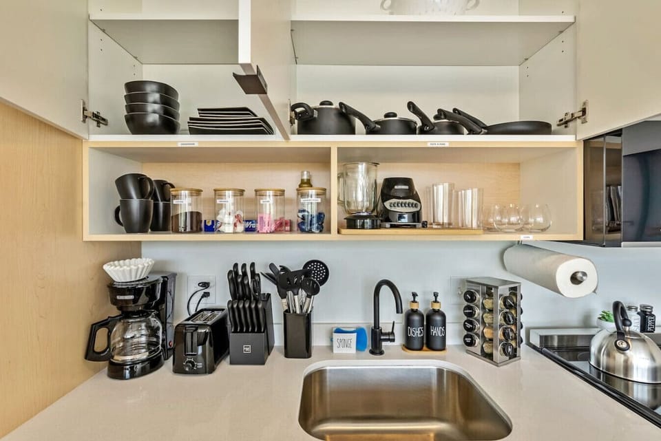 Well-stocked kitchen shelves w/ coffee setup, cookware & essentials at your fingertips