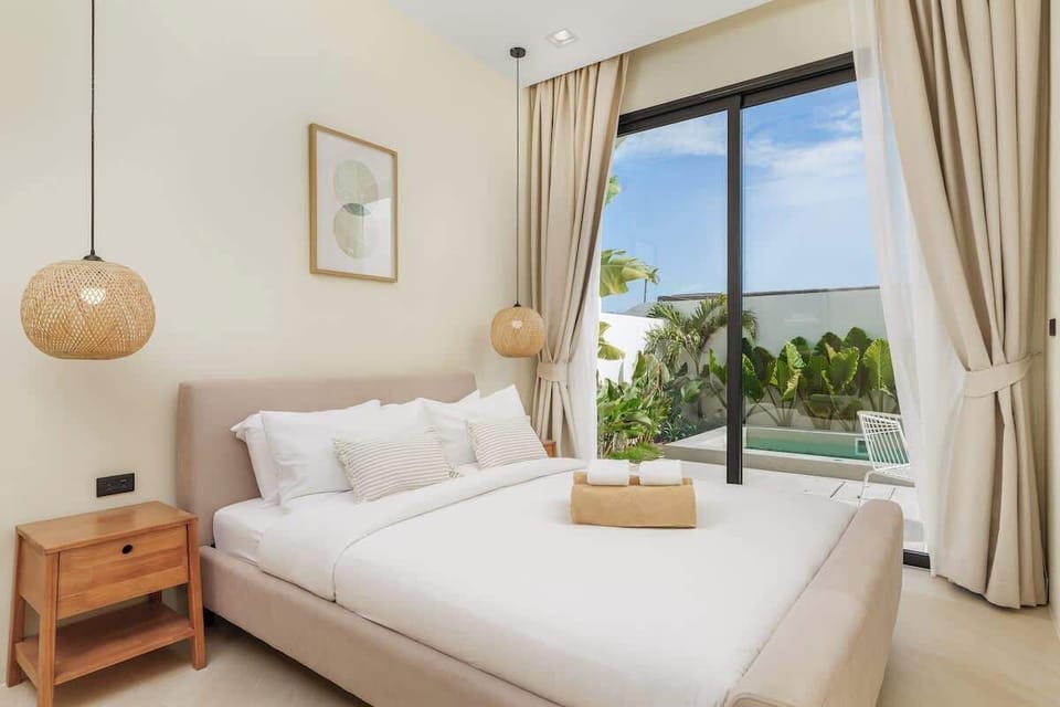 Bedroom 1 has a king-size bed, 2 large windows with sliding doors and black-out curtains. You have access to the pool and garden shared with Bedroom 2.