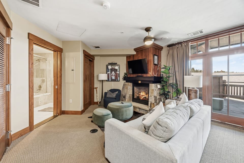Bright Living Room with Fireplace & Private Balcony Access
