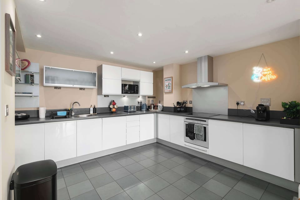 Modern, fully equipped kitchen with everything you need to prepare home-cooked family meals, including a washing machine, dishwasher, microwave, oven, fridge and freezer