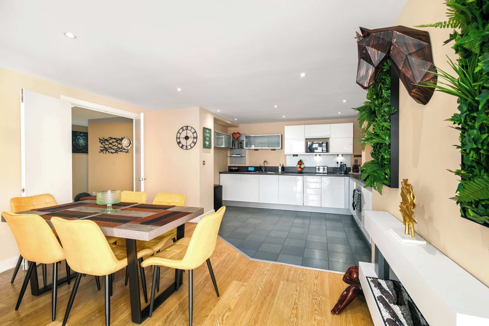 The heart of the home—a stylish kitchen and dining area, fully equipped with modern appliances including a washing machine, dishwasher, microwave, oven, fridge and freezer, making it easy to cook, dine and enjoy memorable meals together
