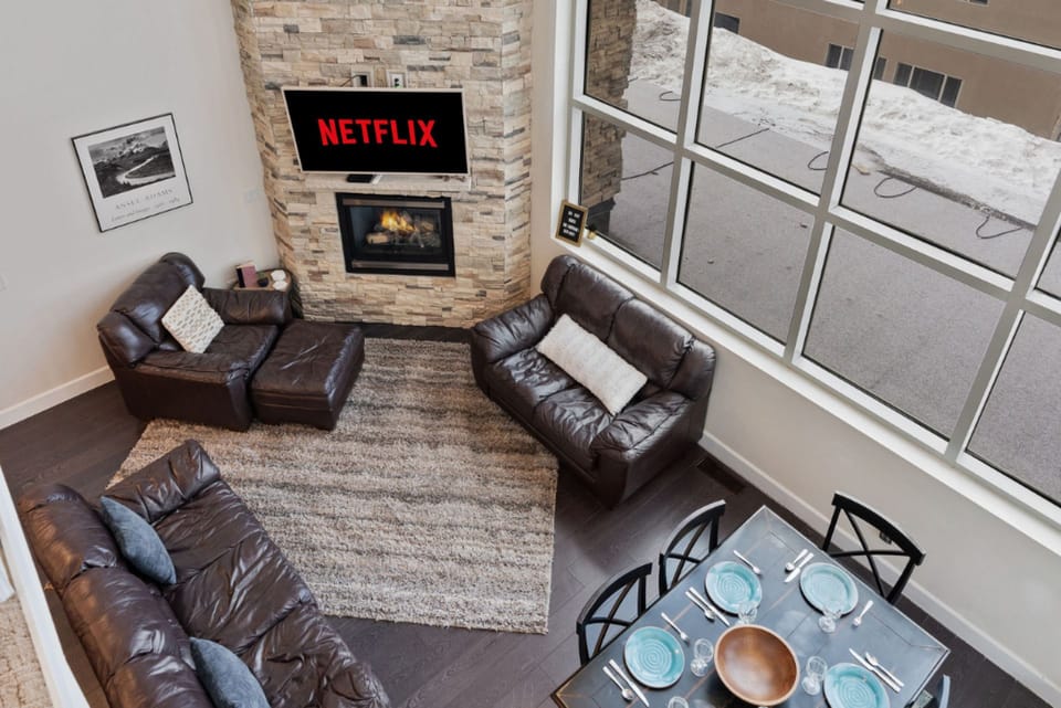This is the view of the living room from the second floor, showcasing its cozy charm!  | Giant Steps Retreat, Brian Head, Utah | Voyax Luxury Vacation Rentals