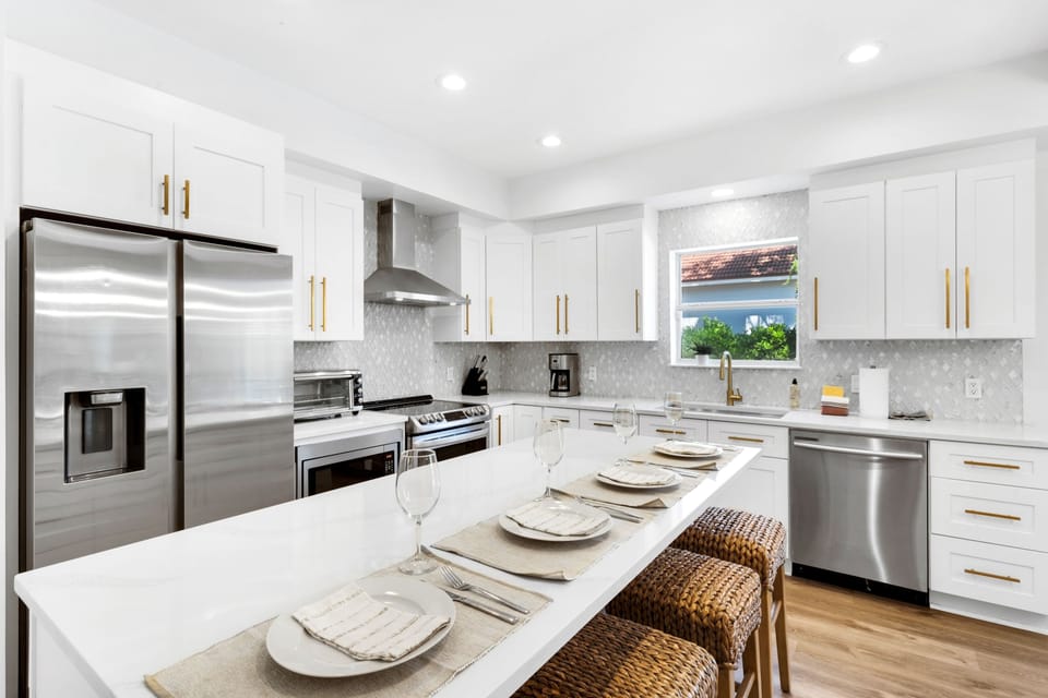 The kitchen has everything you need to whip up family meals, plus a fun breakfast island for quick bites and chatting! | White Sands, Paradise Isles, Destin | Voyax Luxury Vacation Rentals