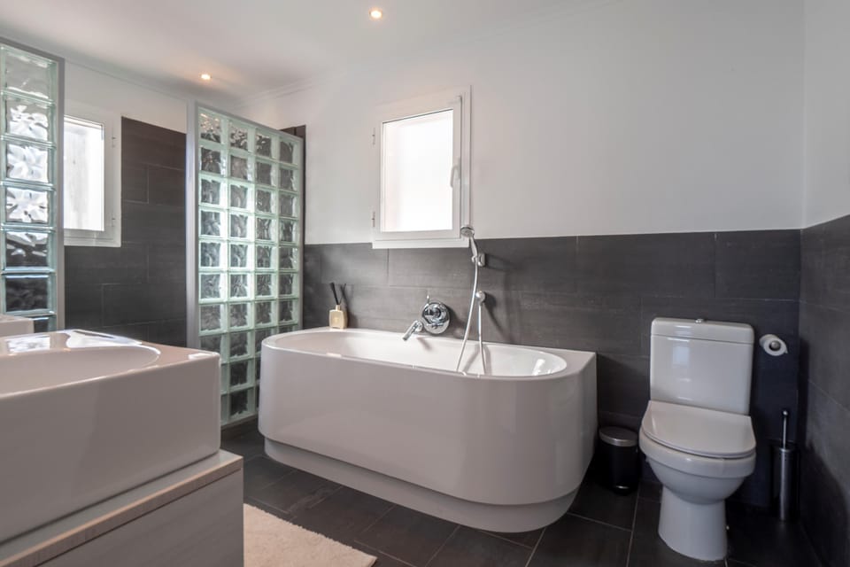 Bathroom with bath and shower
