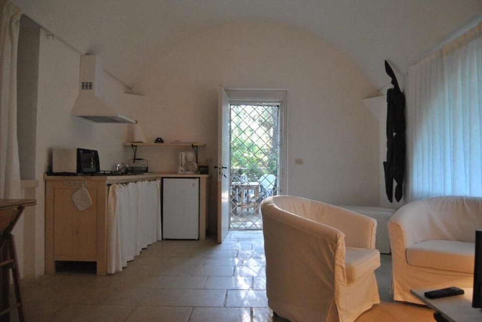 Classic Apartment, Patio | Living area | 24-inch TV with cable channels