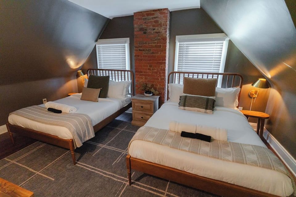 A serene bedroom with two inviting double beds that has a welcoming atmosphere for relaxation and restful nights.



