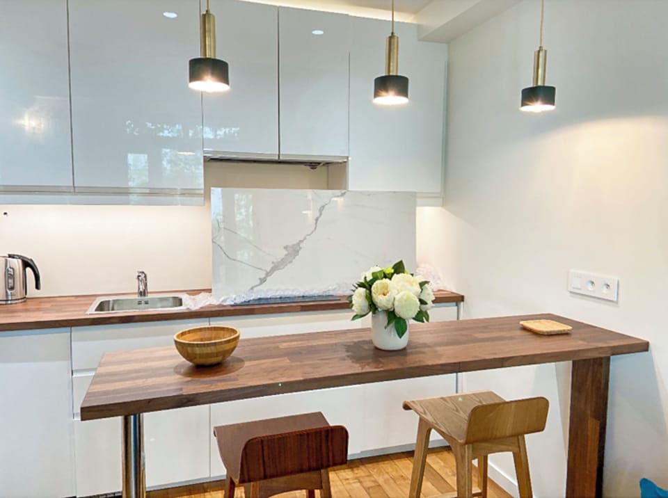 Cooking and serving is convenient as bar is parallel to the kitchen