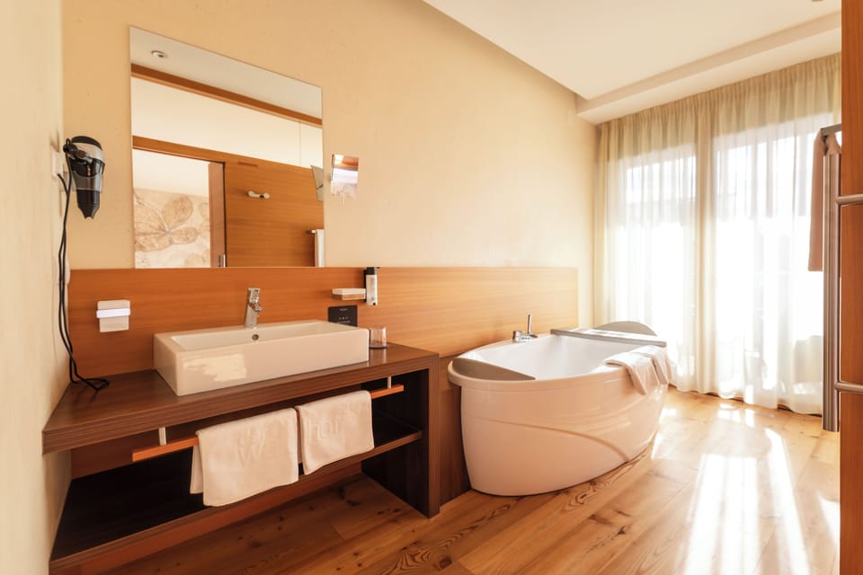 Deluxe Double Room, Balcony, Garden View | Bathroom | Separate tub and shower, hair dryer, bathrobes, slippers