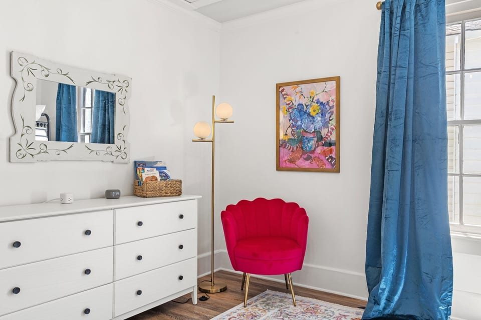 Vibrant art, a cozy chair, and a selection of books create the perfect spot for bedtime story time!