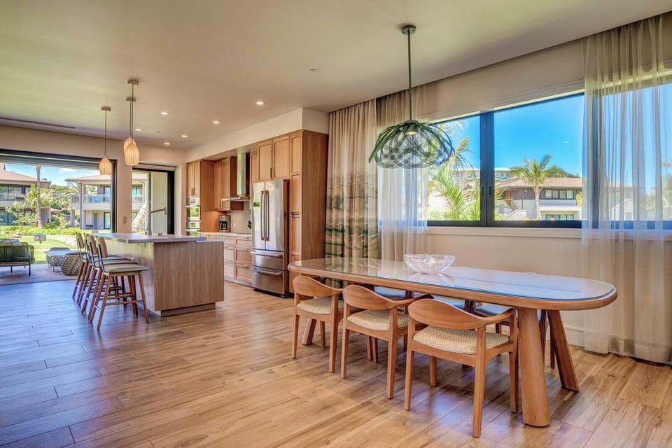 Modern kitchen with oversized island, warm wood cabinets and stunning indoor-outdoor flow HKL-12B