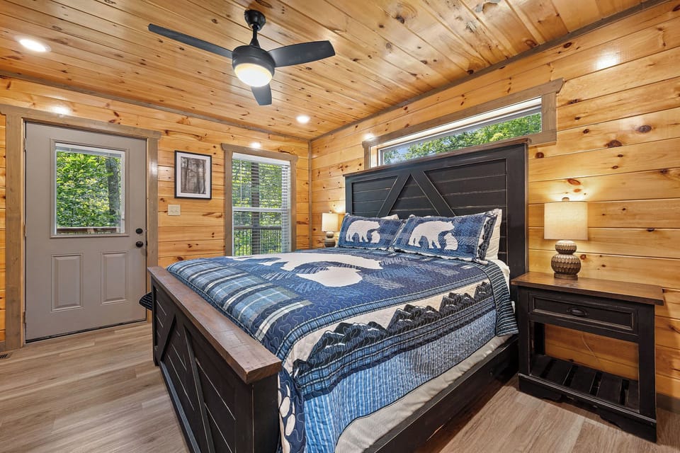 1 king bed with natural lighting and balcony access